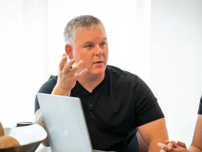 REW CRM - Morgan Carey sitting at table